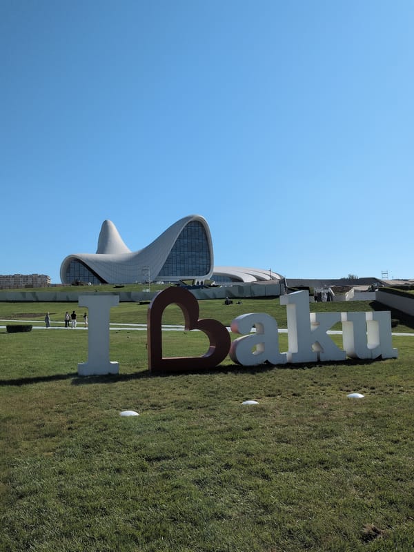 Sunny day around Baku's landmark sign and curved white building