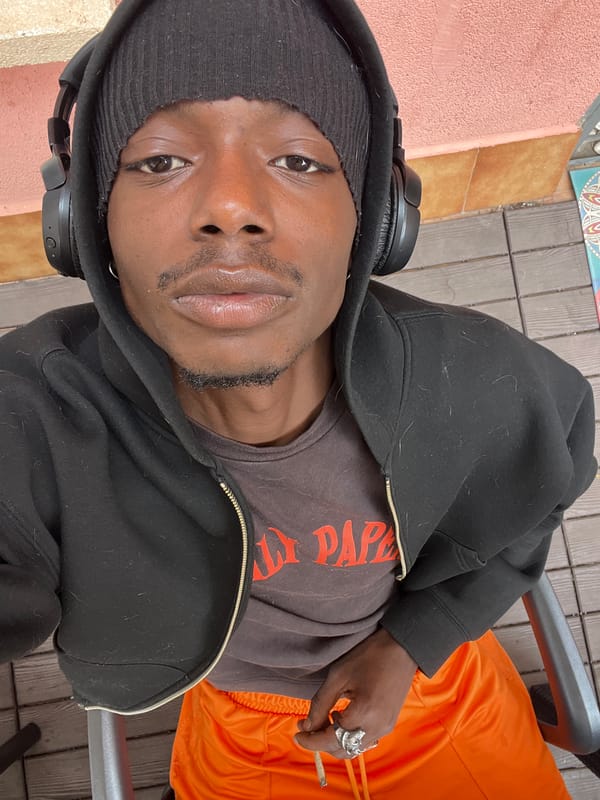 Young man photographed working outdoors with laptop in Barcelona
