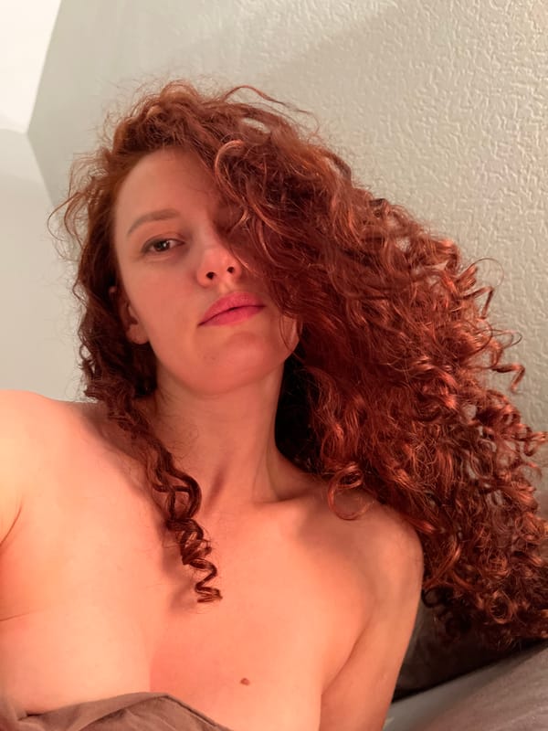 Woman photographed on bed in Saint Petersburg apartment