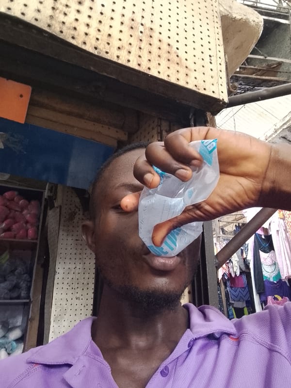 Man counts money at Nigerian market in Fegge