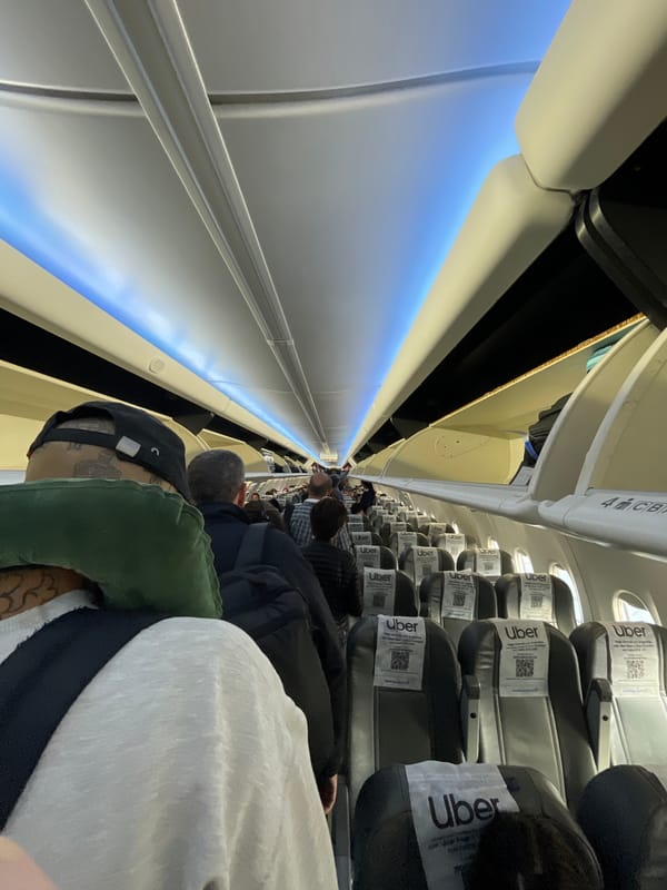 Passenger photographs airplane cabin interior near Ushuaia