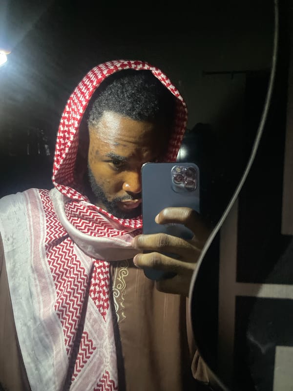 Man in keffiyeh takes multiple selfies in Lokoja