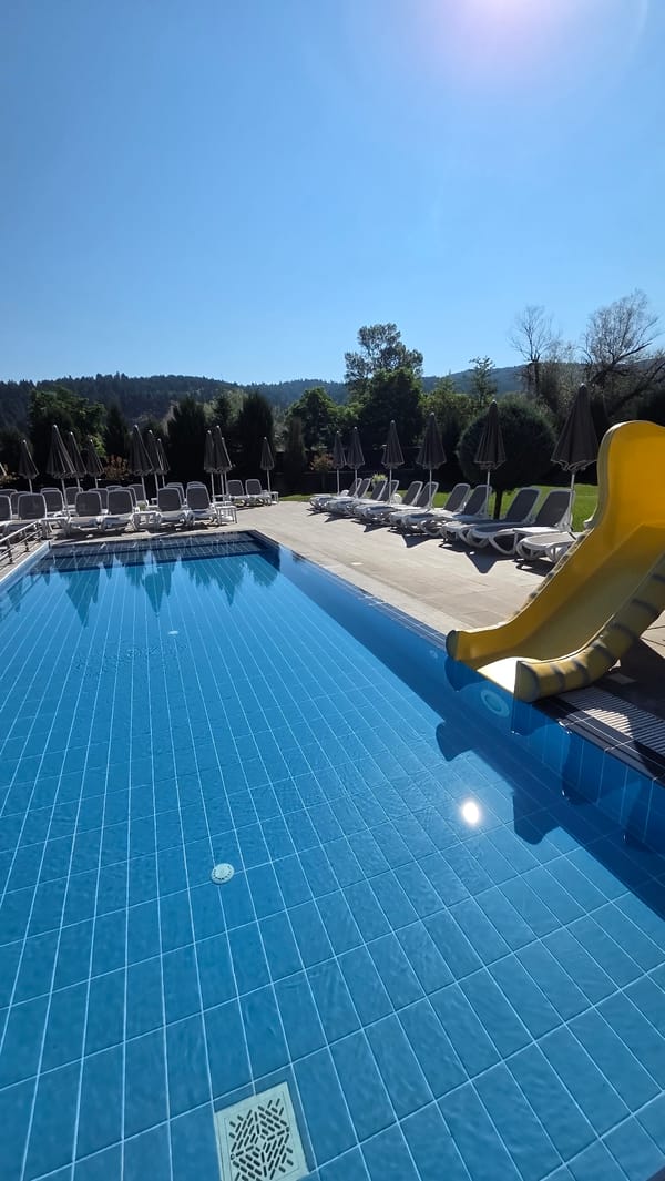 Sunny morning at a resort pool complex in Bania, Bulgaria
