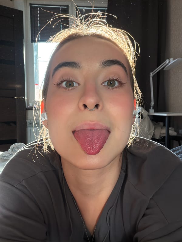 Person takes playful selfies in sunny Krasnoyarsk room