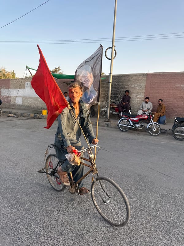 Political procession moves through Quetta streets with flags and vehicles