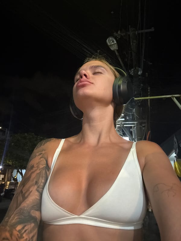 Person in bikini and headphones photographed in North Kuta