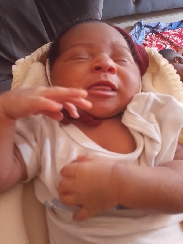 Man and newborn baby photographed at undisclosed location