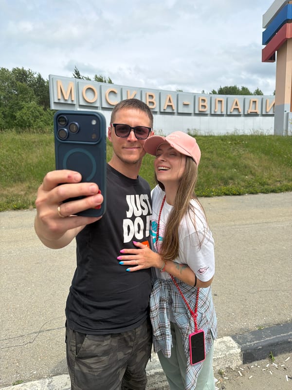 Road trip stop at the Moscow–Vladivostok highway sign