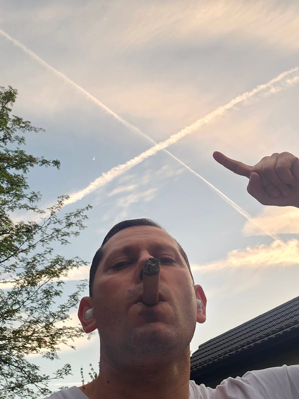 Man smoking cigar with earbuds observed in London