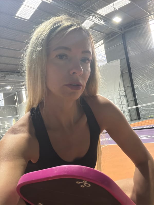 Selfie with a pickleball paddle at an indoor court in Da Lat