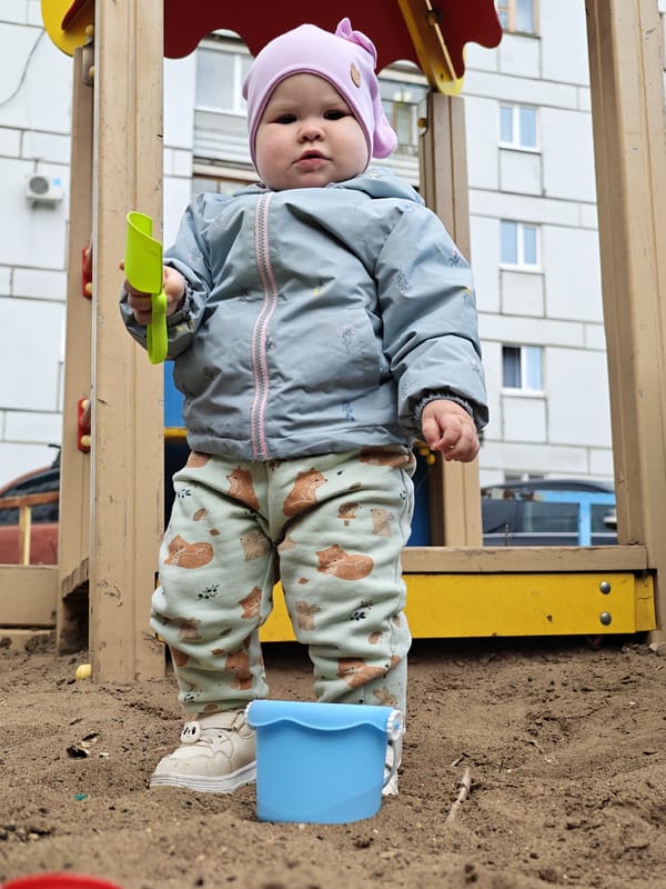 Parent and toddler enjoy playground time in Chaikovsky, Russia