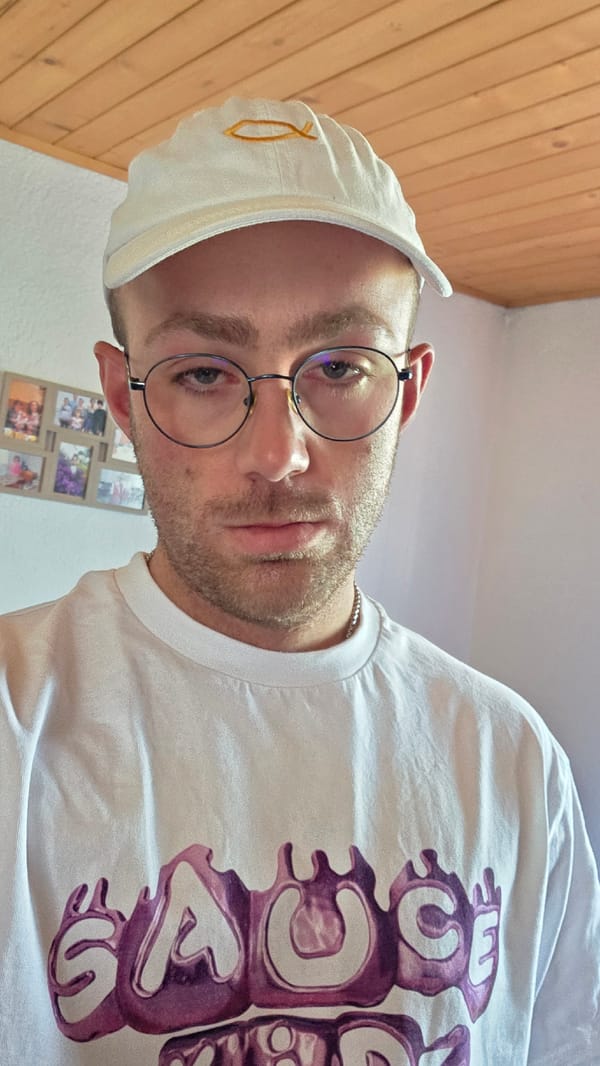 Casual close-up selfie, white baseball cap