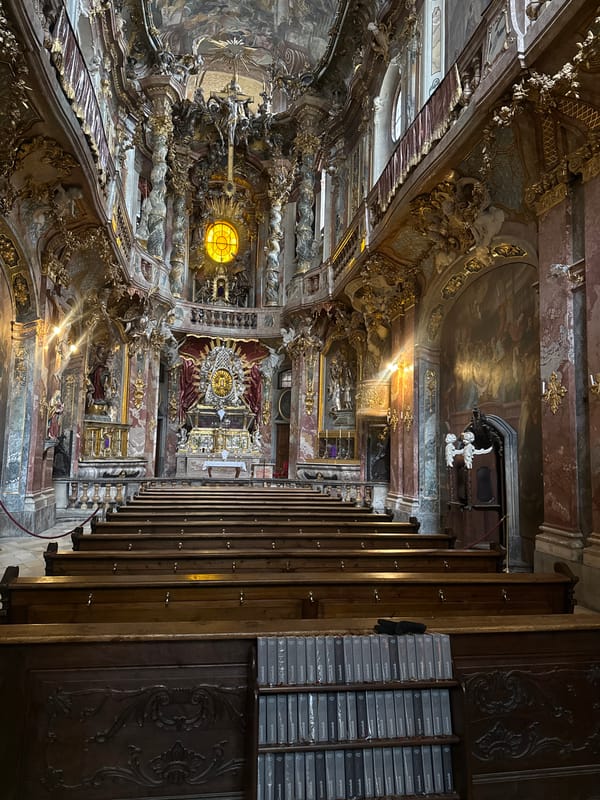 Tourists document ornate Asam Church interior in Munich