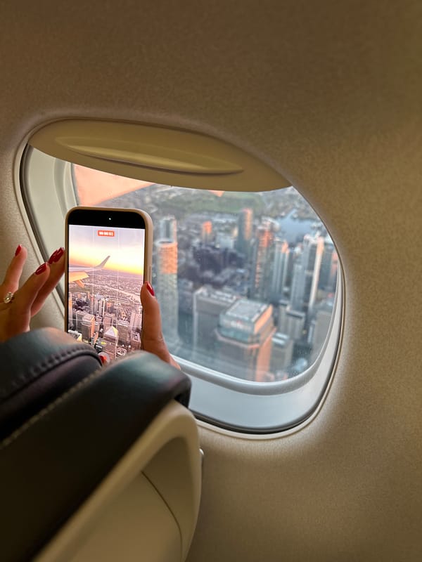 Passenger photographs view from airplane window with mobile phone