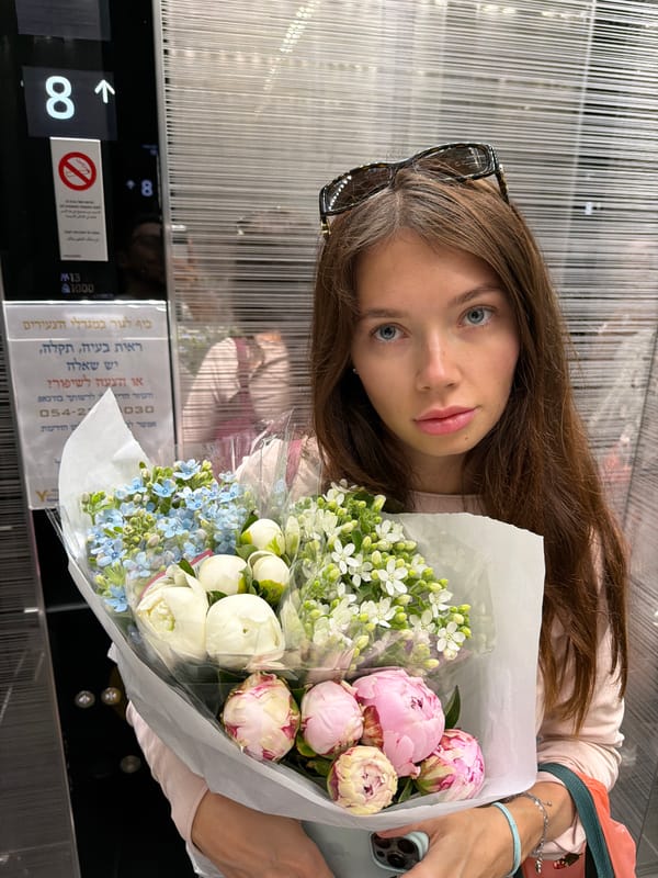 Woman with flower bouquet observed in Tel Aviv elevator