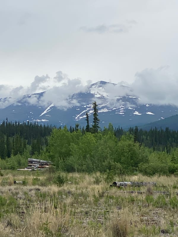 Snow-capped peaks and cloud cover in the Yukon wilderness