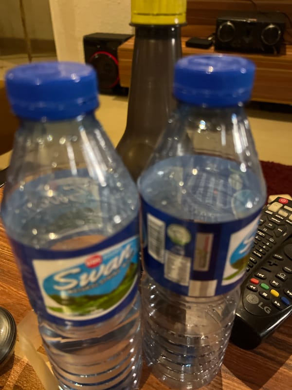 Router, Wi-Fi extender, and water bottles in a Jos interior