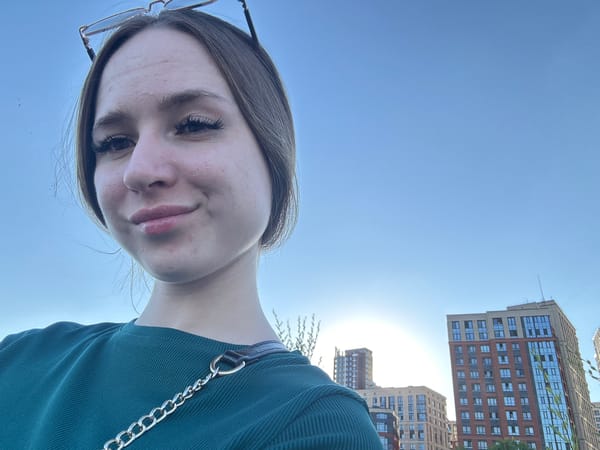 Selfie session on a city overlook, bright day, green top