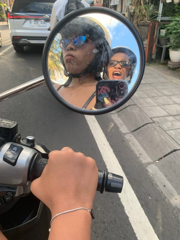 Busy North Kuta street scene: traffic, tangled wires, and local life