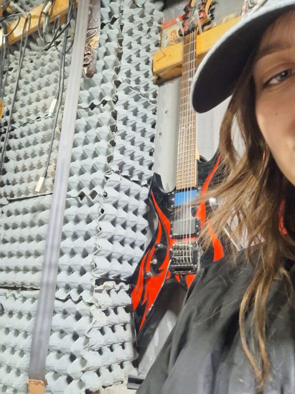 Musician photographed with guitar in Bulgarian rehearsal studio