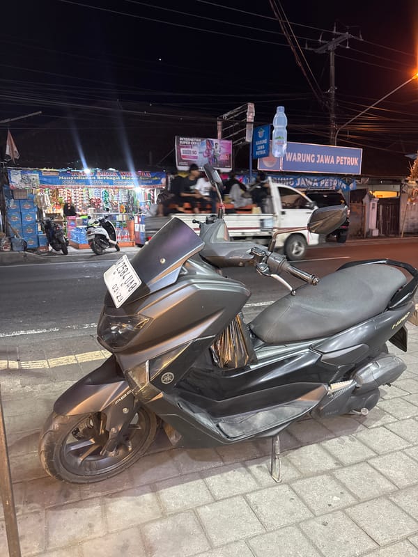 Nighttime street scenes around a Denpasar commercial strip