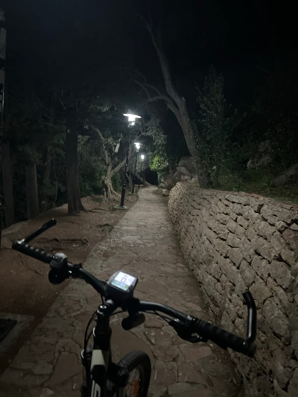 Cyclist documents nighttime coastal views in Rađenovići, Montenegro