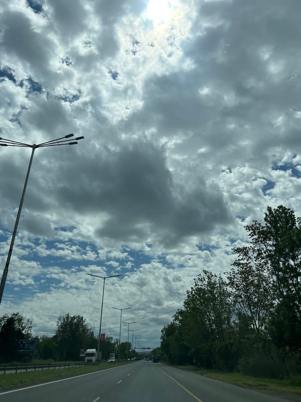 Vehicle travels through Burgas streets under cloudy skies
