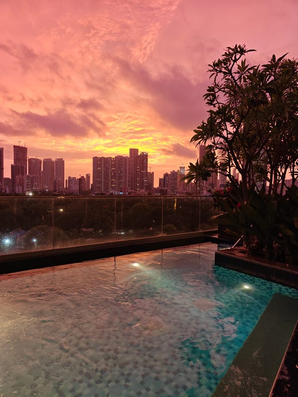 Rooftop pool evening above the Mumbai skyline at sunset