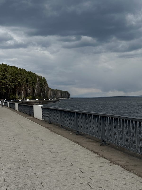 Overcast morning documented at waterfront promenade with bronze statue
