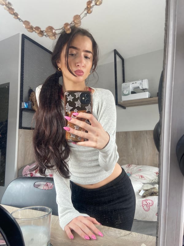 Woman takes multiple mirror selfies in London bedroom