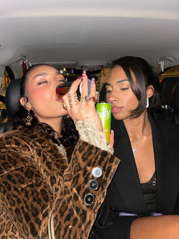 Women share drinks and photos during late-night Paris car ride