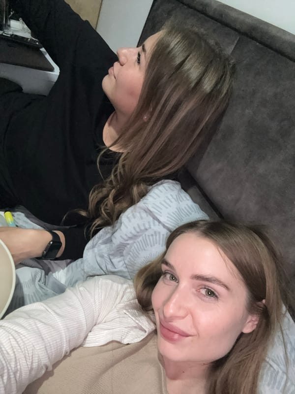 Two women share casual indoor moments in Budva