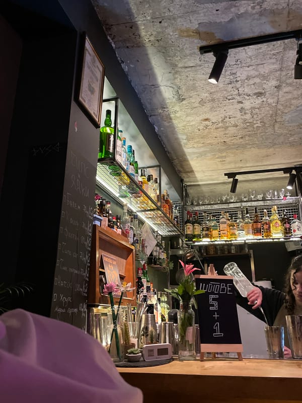 Evening patron documents drinks and comics at Bulgarian bar