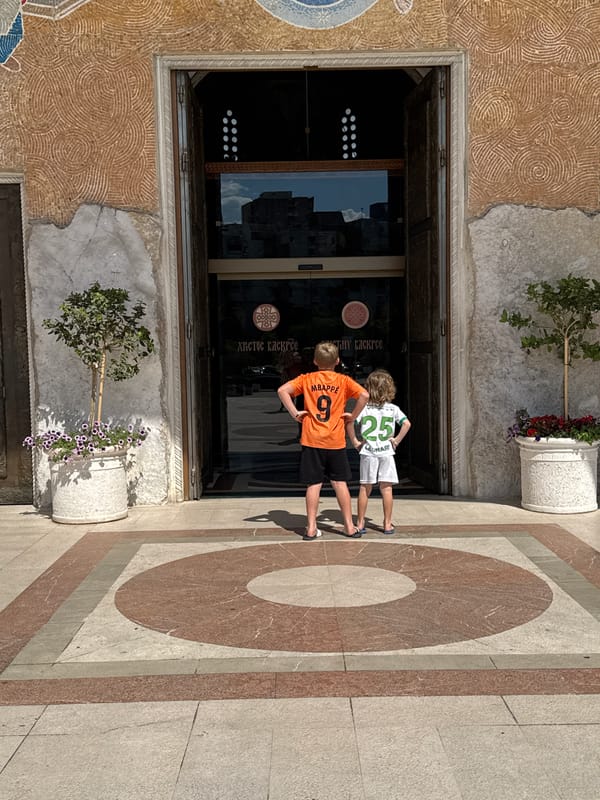 Soccer-clad boys visit ornate cathedral in Podgorica