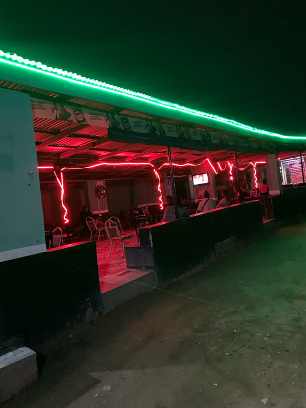 Person enjoys yellow fruit near Nigeria stadium establishments