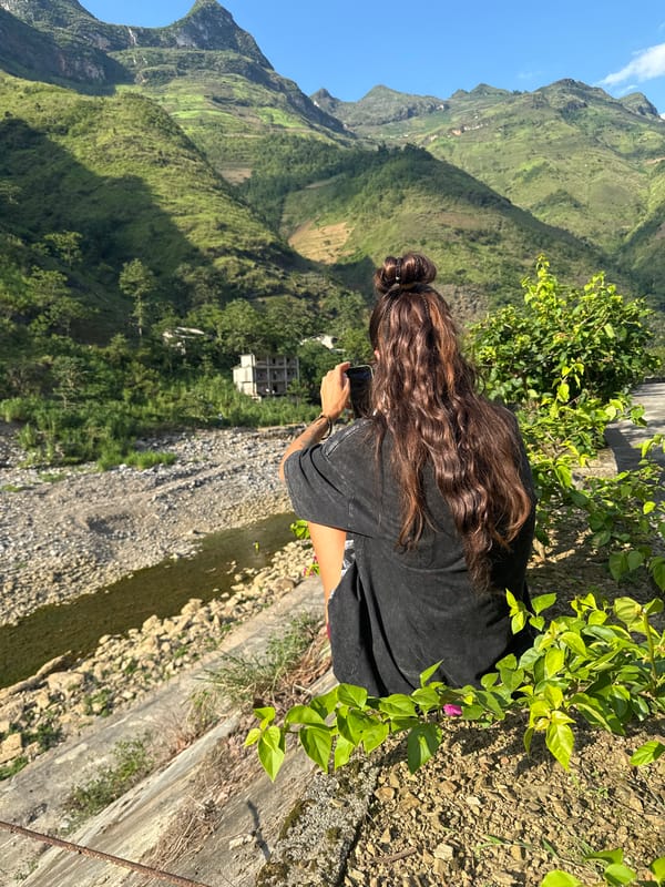 Tourists photograph scenic dam overlook in Vietnamese mountains