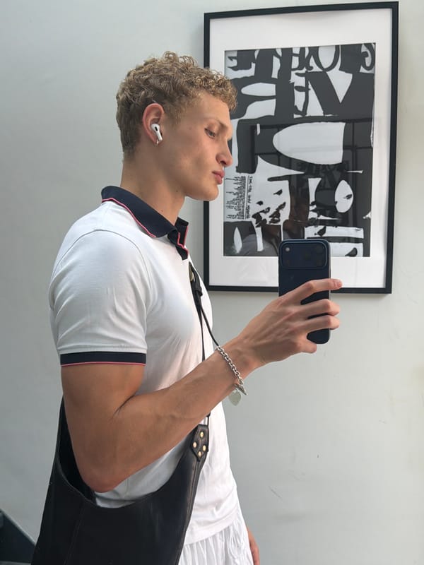 Selfie moment in London, white polo and smartphone in hand