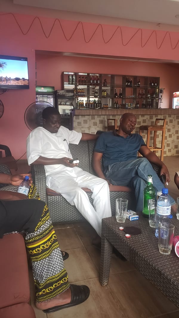 Three men relax together in bar lounge setting