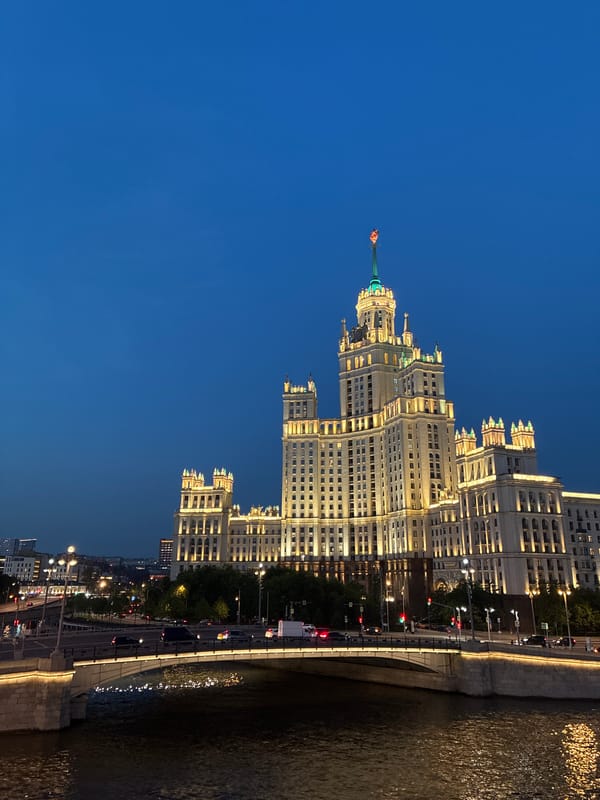 Moscow's Kotelnicheskaya Building illuminated against evening sky