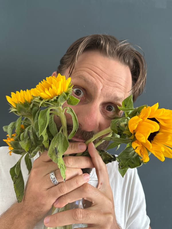 Man photographed in casual portraits with sunflowers in Fethiye