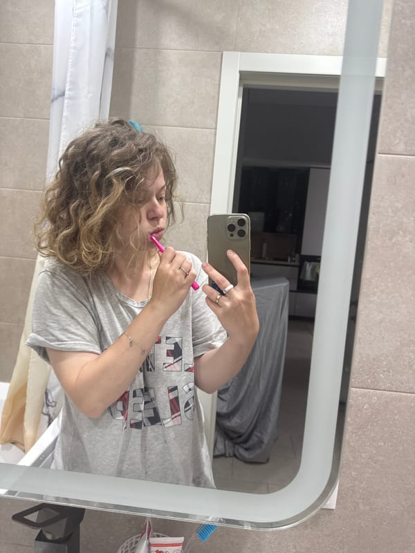 Morning bathroom routine in Mikhaylovsk, multitasking with phone