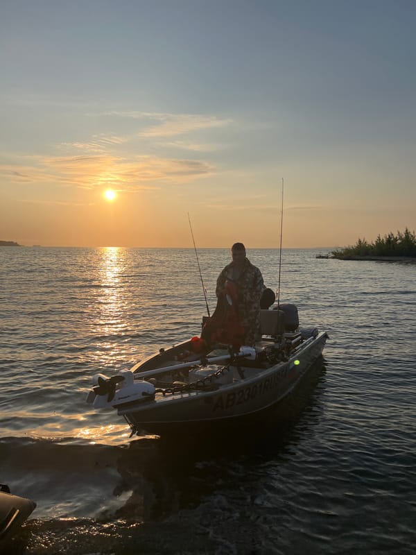 Fishing boat at sunset on the water near Borovoye, Russia