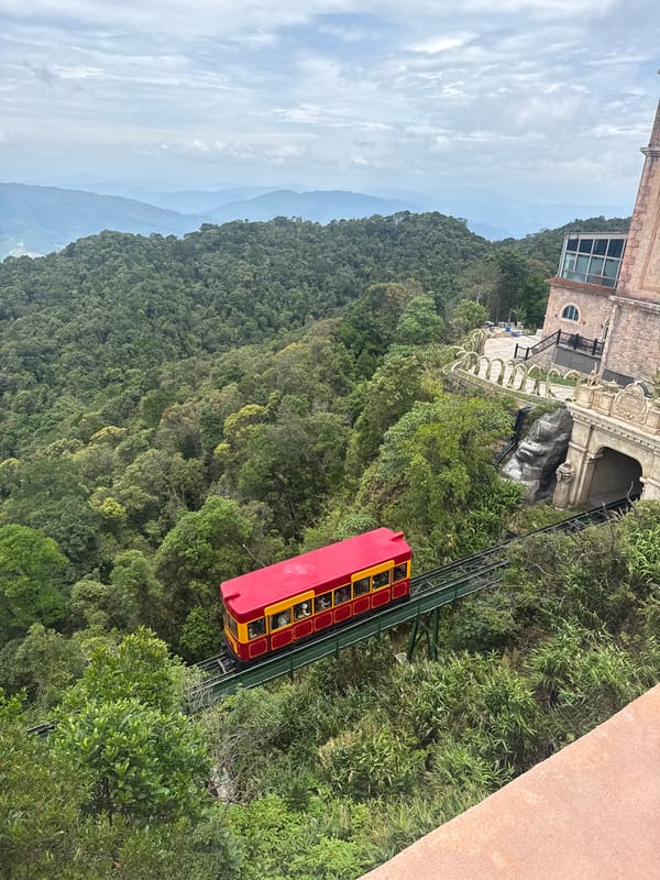 Funicular climbing a green mountain slope near Đà Nẵng