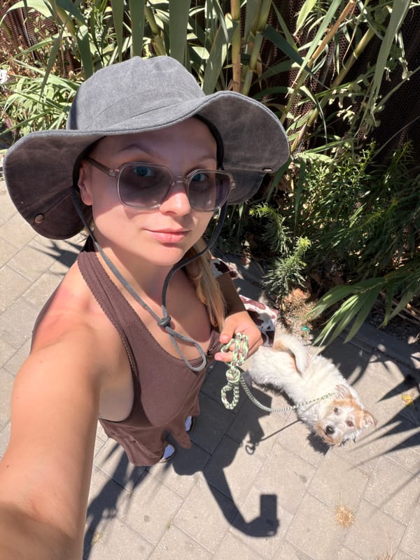 Woman takes sunny day selfies with dog in Tel-Aviv