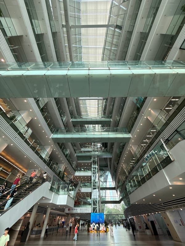 Modern building atrium with glass-steel design documented by observer