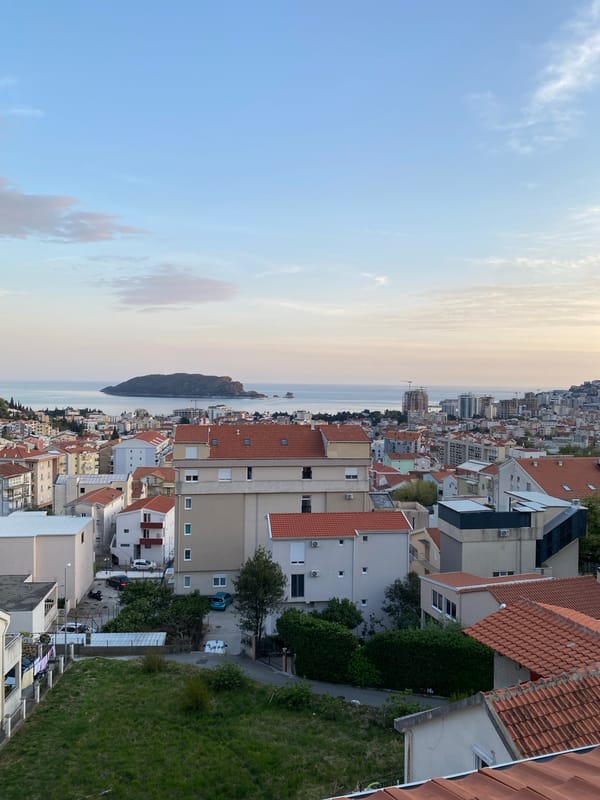 Witness documents evening views of Budva's coastal cityscape