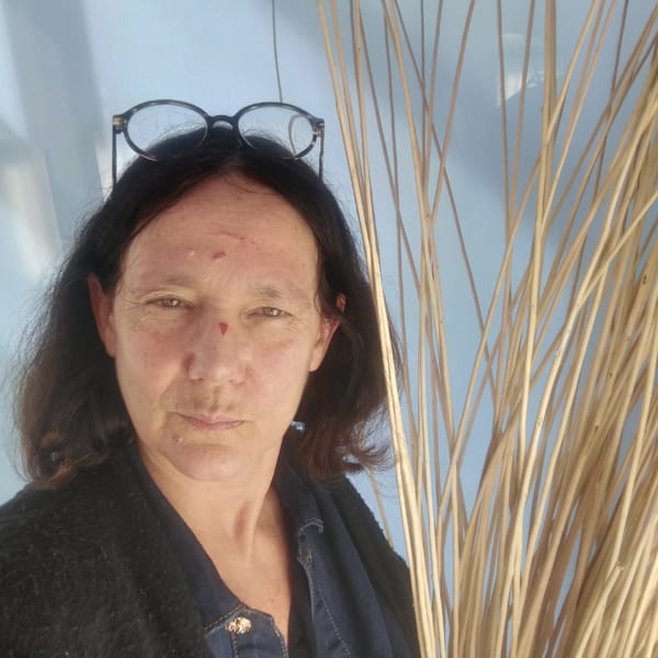 Individual with red skin marks observed wearing dark cardigan