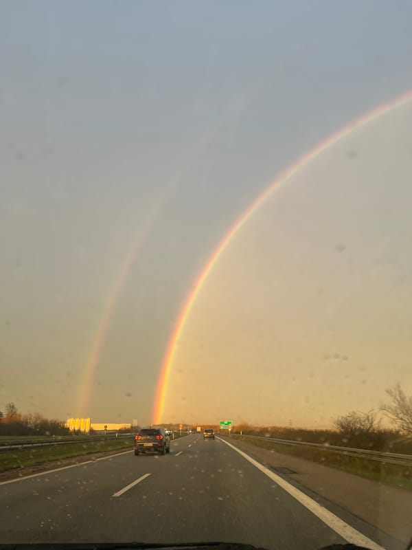 Double rainbow appears over highway in Rebild, Denmark