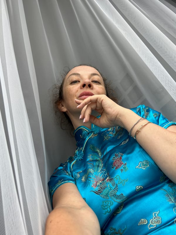 Indoor photo session featuring a blue embroidered silk dress