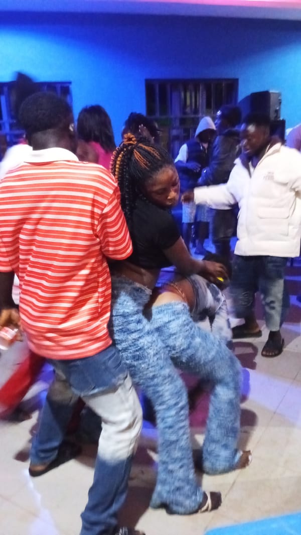 Dancing and DJ vibes at a blue-lit indoor party